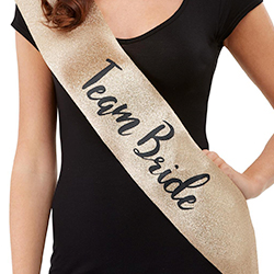 The gold sash modelled by someone wearing a black top.