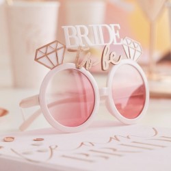 The glasses on a table with other hen party items.