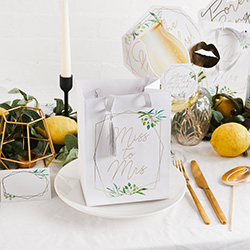 The gift bag surrounded by other accessories.