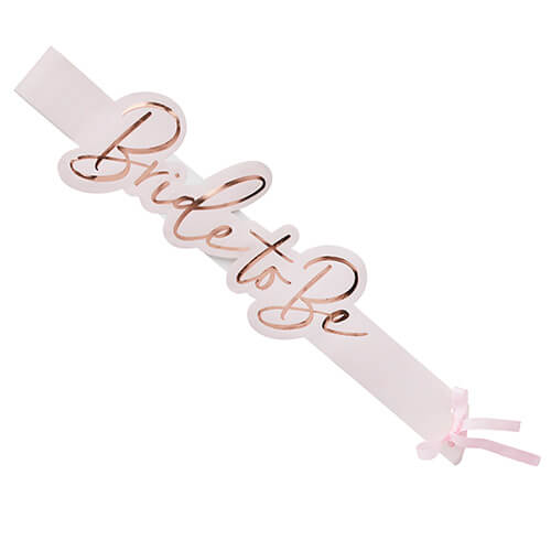 The rose gold bride to be sash against a white background.