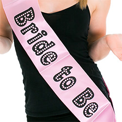 A model wearing the bride to be sash