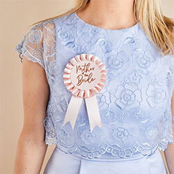 The rosette on a girl in a blue dress.