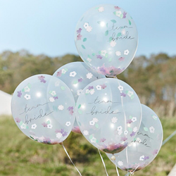 The balloons outside against a blue sky.