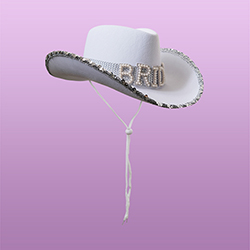 A white cowboy hat that reads 'BRIDE' with a sparkly silver trim. 