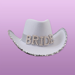 A white cowboy hat that reads 'BRIDE' with a sparkly silver trim. 